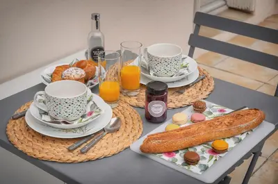 a table with two cups and plates of breakfast food at La Terrasse in Cannes