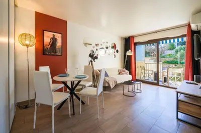a living room with a table and chairs and a couch at Chic Cinema Apartment in Cannes in Cannes
