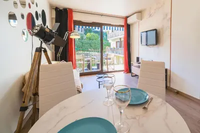 a dining room with a table with wine glasses on it at Chic Cinema Apartment in Cannes in Cannes
