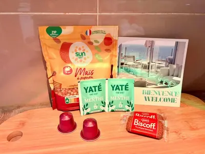 a shelf with three boxes of food on a table at Chic Cinema Apartment in Cannes in Cannes
