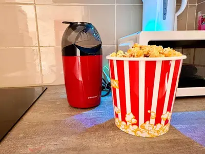 a bottle of soda and a bucket of popcorn at Chic Cinema Apartment in Cannes in Cannes