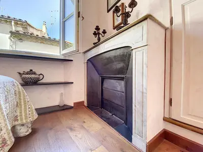a living room with a fireplace and a window at Saint Antoine Mas1410 in Cannes