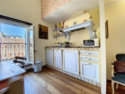 a kitchen with white cabinets and a microwave at Saint Antoine Mas1410 in Cannes