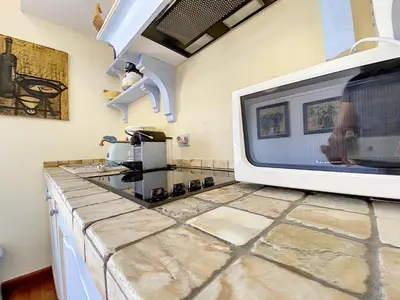 a microwave sitting on top of a kitchen counter at Saint Antoine Mas1410 in Cannes