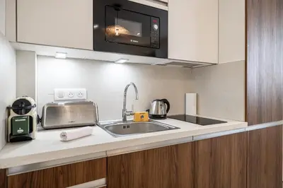 a kitchen with a sink and a microwave at 27 VAURTIN - Modern and renovated studio Cannes city centre in Cannes