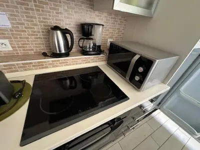a kitchen with a microwave and a stove top oven at Studio w parking, close to film Festival Palace in Cannes