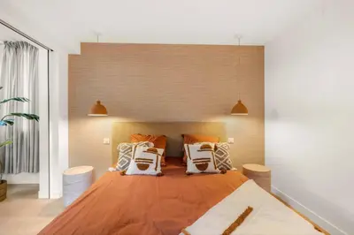 a bedroom with a large bed with orange and white pillows at 121 MARECHAL - 3-Bedroom Apartment Sea View and Parking in Cannes