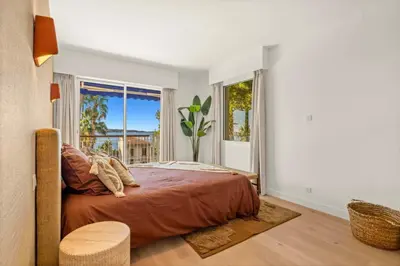 a bedroom with a bed and a large window at 121 MARECHAL - 3-Bedroom Apartment Sea View and Parking in Cannes