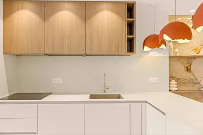 a kitchen with white cabinets and a sink at 121 MARECHAL - 3-Bedroom Apartment Sea View and Parking in Cannes