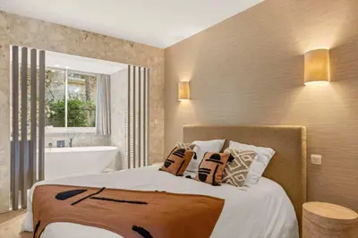 a bedroom with a bed and a bath tub and a bath tub at 121 MARECHAL - 3-Bedroom Apartment Sea View and Parking in Cannes