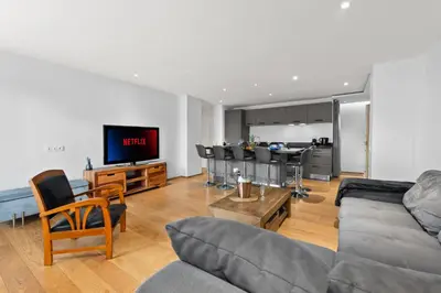 a living room with a couch and chairs and a kitchen at Luxueux deux pièces - Proche de la mer - FU in Cannes