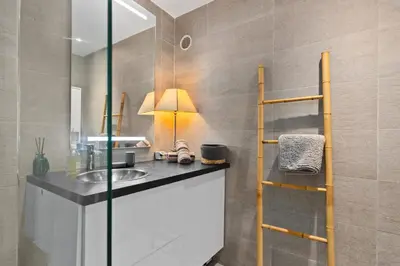 a bathroom with a sink and a glass shower at Luxueux deux pièces - Proche de la mer - FU in Cannes
