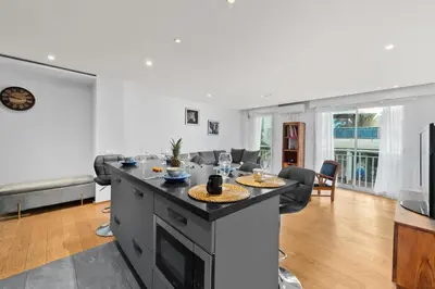 a kitchen with an island in a living room at Luxueux deux pièces - Proche de la mer - FU in Cannes