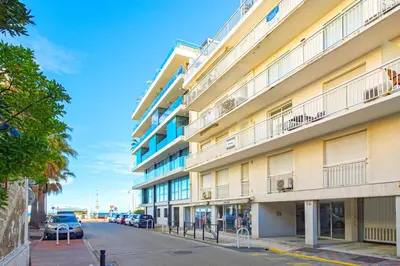a tall building with cars parked on a street at Luxueux deux pièces - Proche de la mer - FU in Cannes