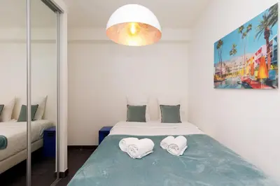 a bedroom with a bed with towels on it at Le Grain d'Or YourHostHelper in Cannes