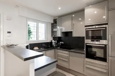 a kitchen with stainless steel appliances and a window at Le Grain d'Or YourHostHelper in Cannes