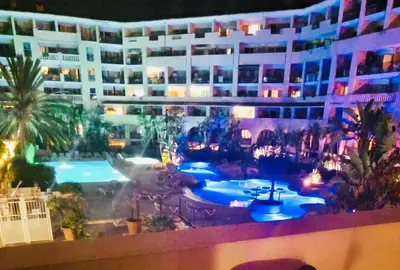 a view of a building with a pool at night at Appartement bord de mer in Cannes