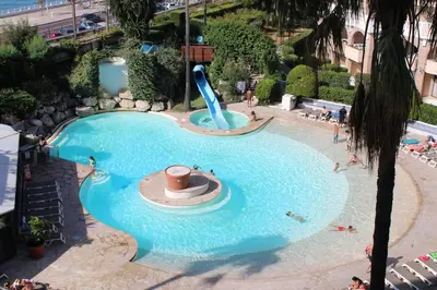 a pool at a resort with a water slide at Sea & Sun Verrerie in Cannes