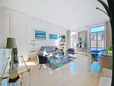 a living room with a couch and a table at Cannes 2 bedrooms & 2 bathrooms Apartment - 43A in Cannes