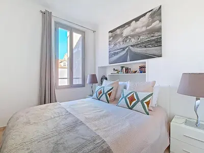 a bedroom with a bed with a large window at Cannes 2 bedrooms & 2 bathrooms Apartment - 43A in Cannes