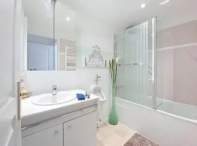 a white bathroom with a sink and a shower at Cannes 2 bedrooms & 2 bathrooms Apartment - 43A in Cannes