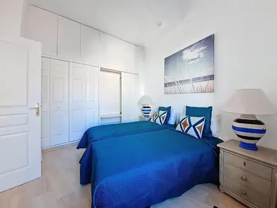 a bedroom with a bed with a blue comforter at Cannes 2 bedrooms & 2 bathrooms Apartment - 43A in Cannes