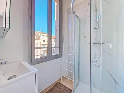 a bathroom with a shower and a sink and a window at Cannes 2 bedrooms & 2 bathrooms Apartment - 43A in Cannes