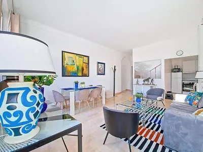 a living room with a vase on a glass table at Cannes 2 bedrooms & 2 bathrooms Apartment - 43A in Cannes