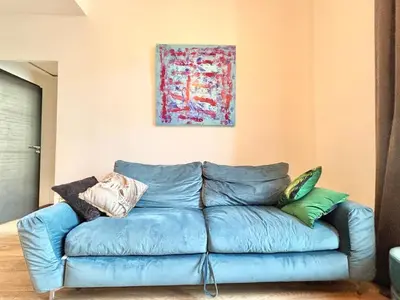 a blue couch in a living room with a painting at Cannes 1 bedroom apartment - 9BC in Cannes