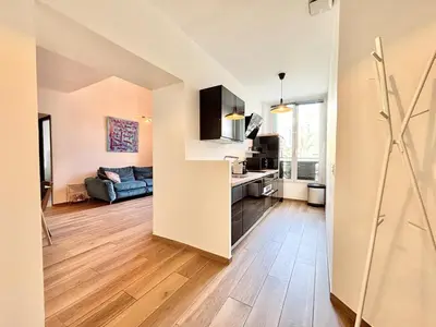 a kitchen and living room with a couch and a table at Cannes 1 bedroom apartment - 9BC in Cannes