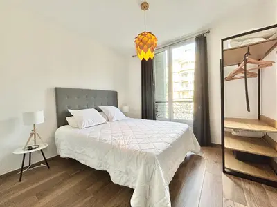 a white bedroom with a bed and a window at Cannes 1 bedroom apartment - 9BC in Cannes