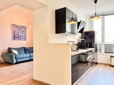a kitchen and a living room with a couch at Cannes 1 bedroom apartment - 9BC in Cannes