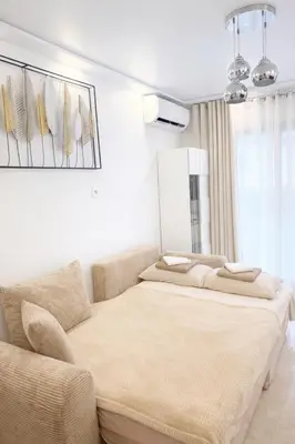 a bedroom with a large bed and a couch at Cannes Center Appartement F9 in Cannes