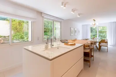 a kitchen with a sink and a dining room with a table at 002 Villa Camille in Cannes