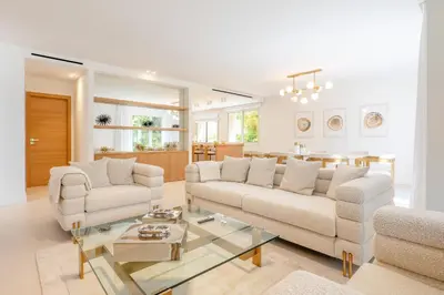 a living room with two couches and a glass table at 002 Villa Camille in Cannes