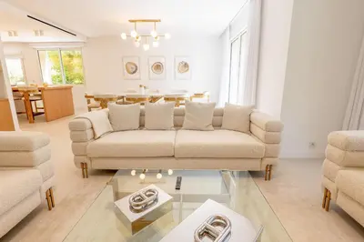 a living room with a couch and a table at 002 Villa Camille in Cannes