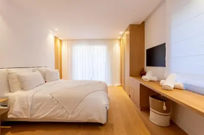 a bedroom with a white bed and a television at 002 Villa Camille in Cannes