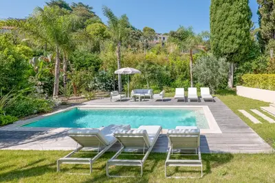a pool with chaise lounge chairs and a swimming pool at 002 Villa Camille in Cannes