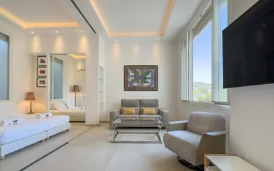 a living room with a couch and a tv at 303 Le Gallia in Cannes