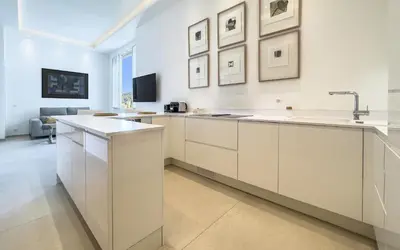 a kitchen with white cabinets and a sink at 303 Le Gallia in Cannes