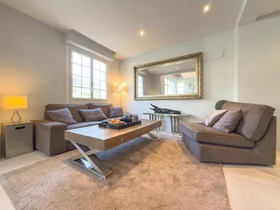 a living room with a couch and a table at Eclat by Winsome Destination in Cannes