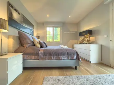 a bedroom with a large bed and a dresser at Eclat by Winsome Destination in Cannes