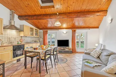 a kitchen and living room with a table and a couch at Le Suquet Apartment - Cannes Old Town - Happy Rentals in Cannes