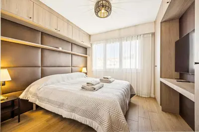 a bedroom with a large bed with towels on it at Magnifique appartement à 50 mètres de la Croisette in Cannes