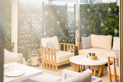 a patio with chairs and tables and plants at Magnifique appartement à 50 mètres de la Croisette in Cannes