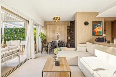 a living room with a couch and a table at Magnifique appartement à 50 mètres de la Croisette in Cannes
