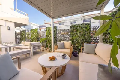 an outdoor patio with white furniture and plants at Magnifique appartement à 50 mètres de la Croisette in Cannes