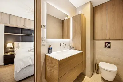 a bathroom with a sink and a toilet and a bed at Magnifique appartement à 50 mètres de la Croisette in Cannes