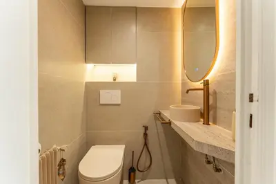a bathroom with a toilet and a sink and a mirror at Magnifique appartement dans le carré d'or à Cannes in Cannes