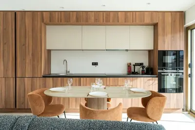 a kitchen with a table and chairs in a room at Magnifique appartement dans le carré d'or à Cannes in Cannes